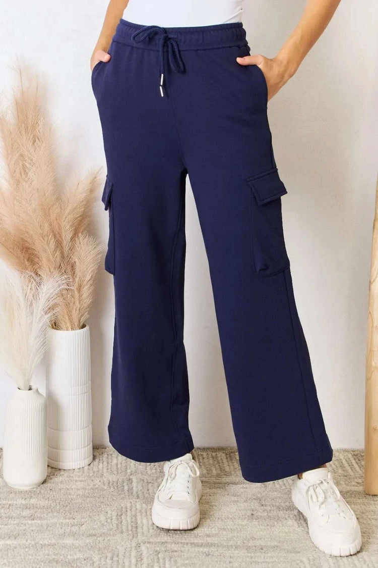 Model wearing RISEN Drawstring relaxed cargo wide leg pants in casual pose