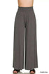 Woman wearing Zenana Smocked Waist wide leg palazzo pants with drawstring pockets and flowy silhouette