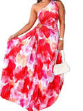 Woman wearing a printed one shoulder asymmetrical maxi dress with ruched detail and slit