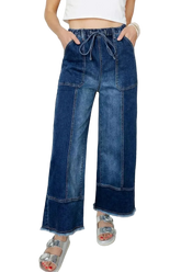 Close-up of raw hem wide leg denim pants with drawstring seam detail