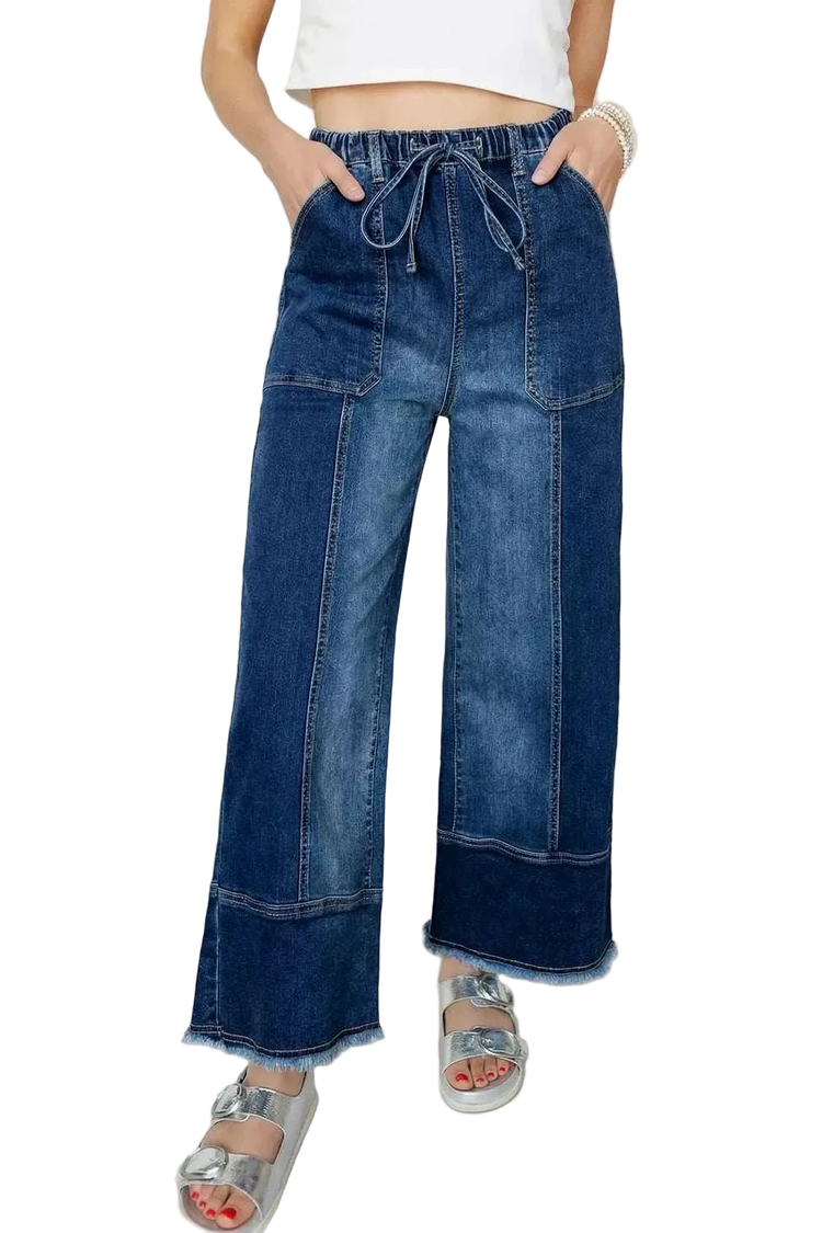 Close-up of raw hem wide leg denim pants with drawstring seam detail