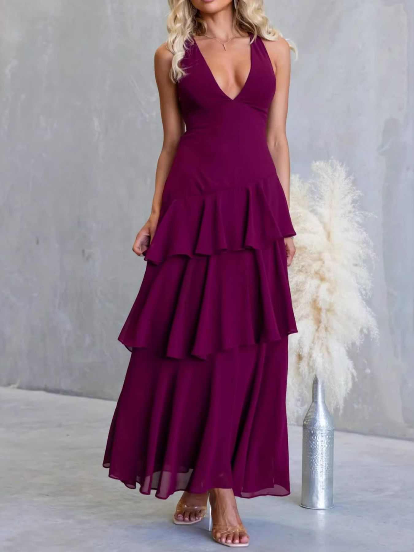 Black sleeveless ruffled layered backless maxi dress with tied detail and no stretch polyester fabric