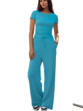 Woman wearing a comfortable short sleeve top and drawstring pants set in casual style