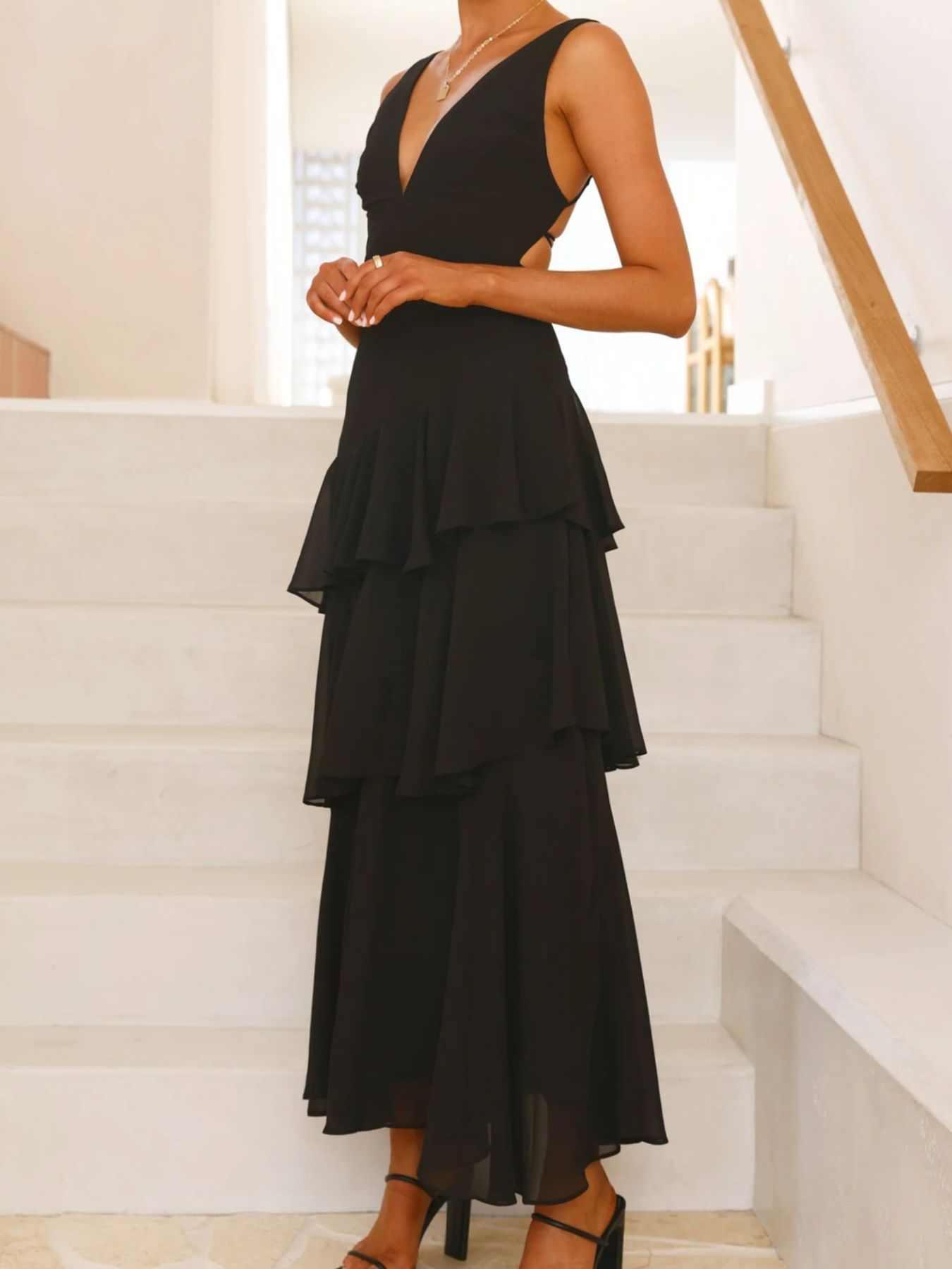 Sleeveless ruffled layered backless maxi dress with tied straps and no stretch made of 100% polyester