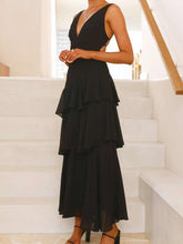 Sleeveless ruffled layered backless maxi dress with tied straps and no stretch made of 100% polyester