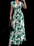 Woman wearing a printed surplice cap sleeve maxi dress with smocked waist and flowy skirt