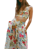 Printed cami and skirt set featuring ruched detailing, pockets, buttons, and slit, made of 100% polyester.