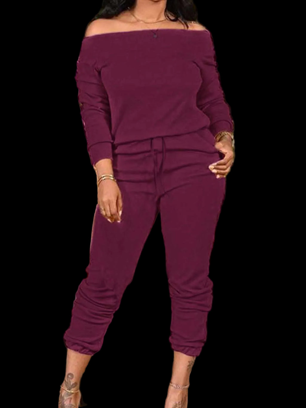 Woman wearing a stylish off-shoulder top and pants set with slight stretch in polyester and elastane blend